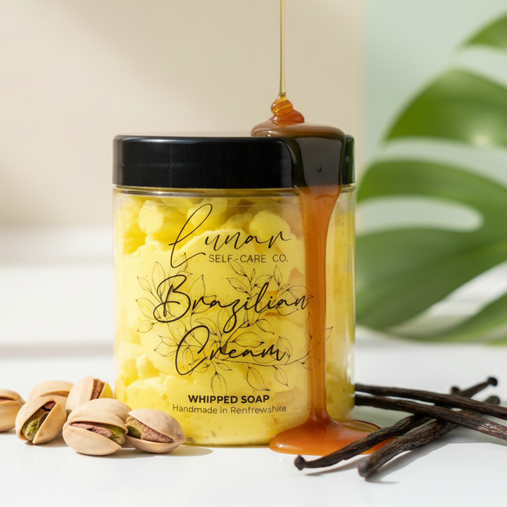 Jar of 'Brazilian Cream' whipped soap with honey drizzle, pistachios, and vanilla beans on a light background.
