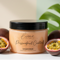 Jar of 'Passionfruit Cocktail' sugar scrub from Lunar Self-Care Co. with passionfruits on a light background.
