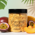 Jar of 'Passionfruit Cocktail' whipped soap with tropical fruits on a light background