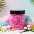 Snow Pixie scented pink whipped soap jar with candy and cotton candy on a light background