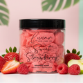 Jar of red 'Sweet Strawberry' whipped soap with strawberries and raspberries on a light background